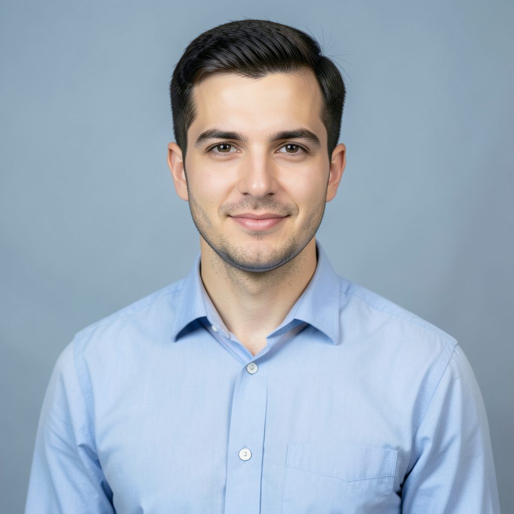 Professional headshot placeholder with a button-down shirt against a soft blue-gray background