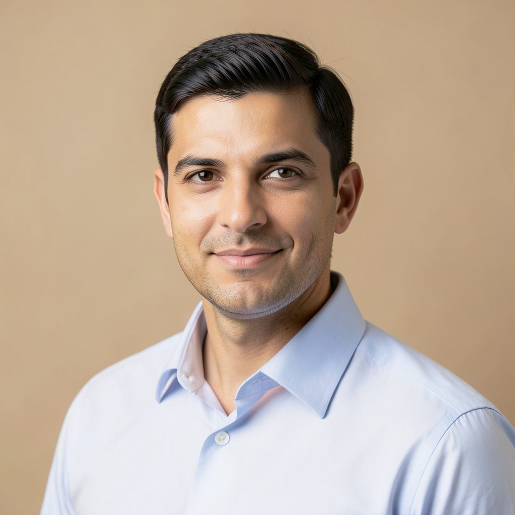 Professional headshot placeholder with a collared shirt against a warm neutral backdrop